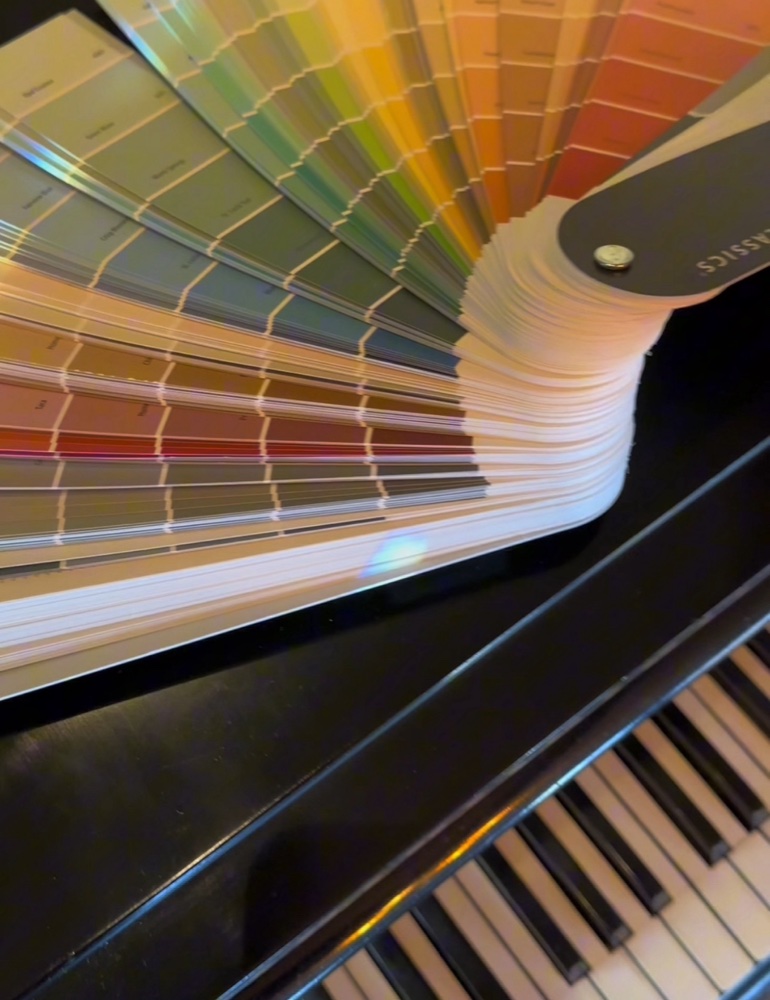 Paint color swatches over piano keys — visual metaphor for tonal color