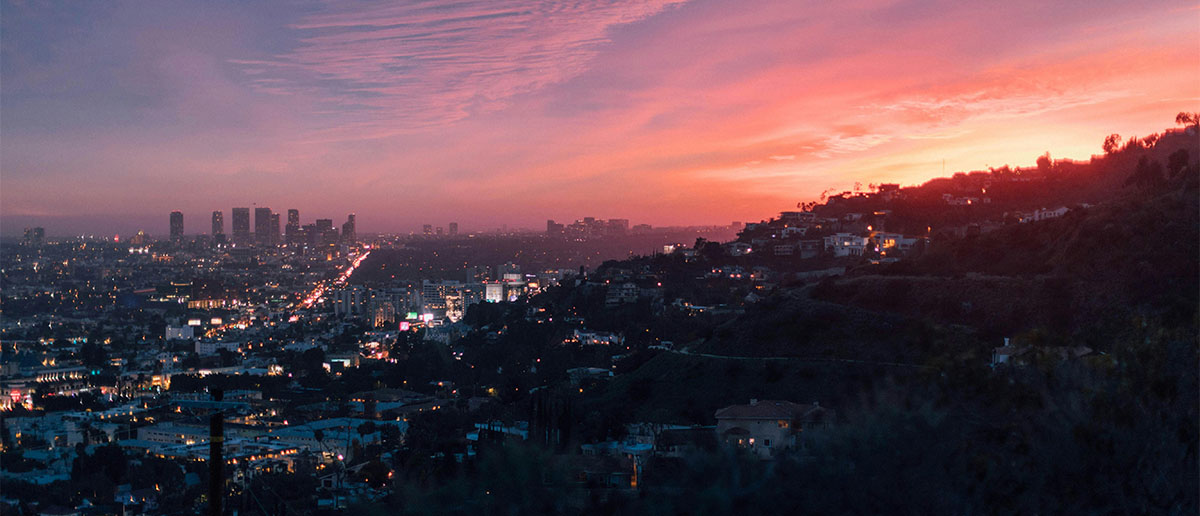 Los Angeles skyline at sunset from a hilltop